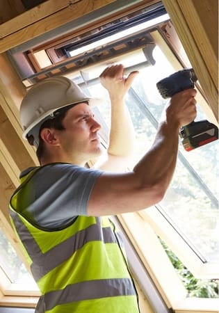 handyman using electric drill on window sill at townsville handyman